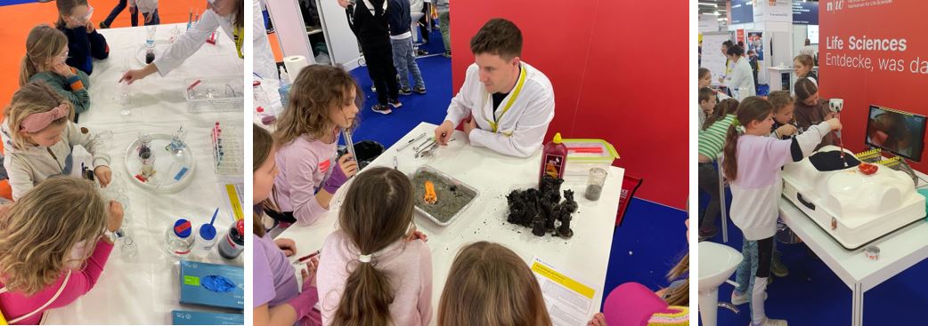 Impressionen von der tunBasel. Mehrere Kinder stehen um einen Tisch und arbeiten/basteln/experimentieren mit einer Person im weissen Kittel der Life Sciences. 
