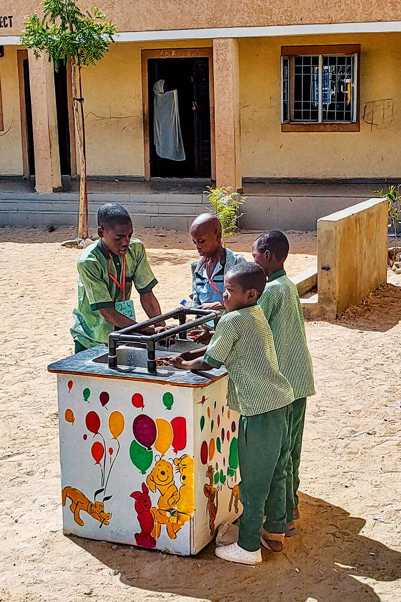 School children in a primary school in Maiduguri, Borno State, Nigeria use a Gravit`eau handwashing system.